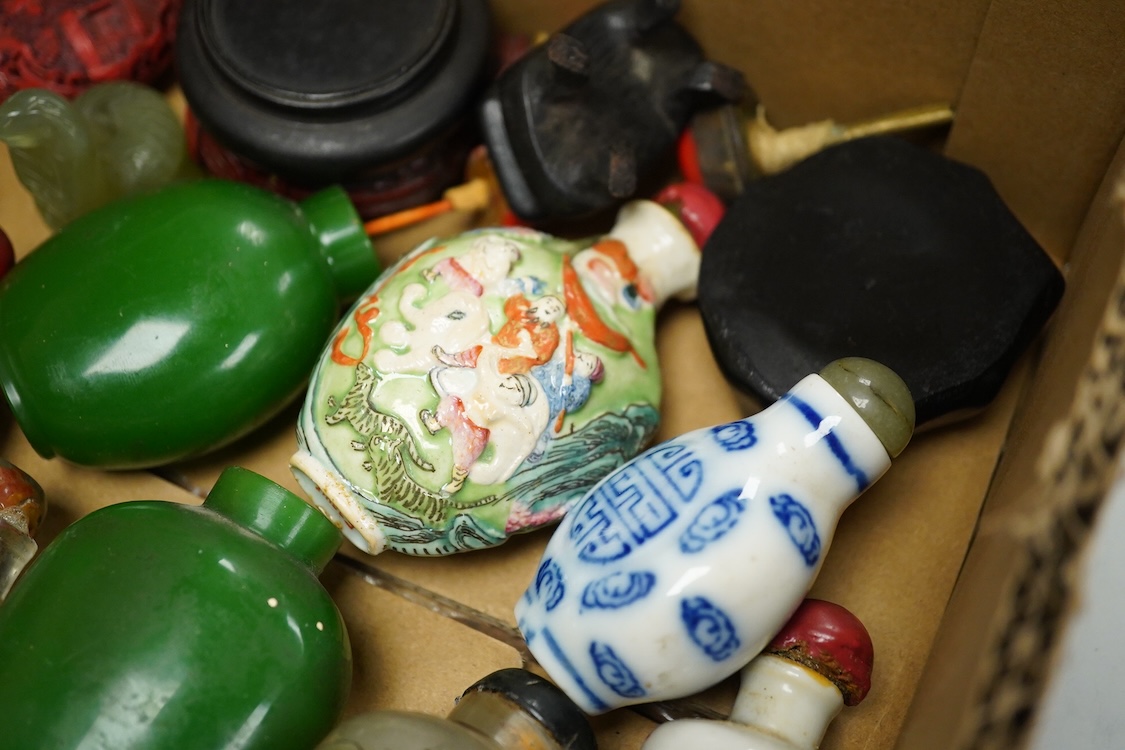 A small collection of Chinese snuff bottles, 19th century and later to include reverse glass painted examples and cinnabar lacquered examples, largest 9.5cm high